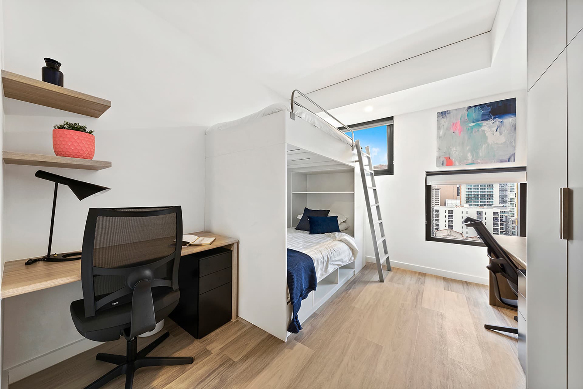 Twin Bunk Apartment at Scape Waymouth featuring bunk beds, two dedicated study desks, built-in storage and windows with city views.